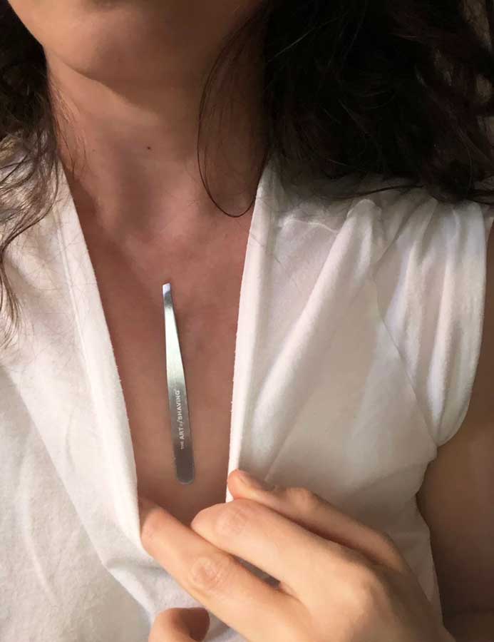 Woman with small tweezer magnetized to her chest